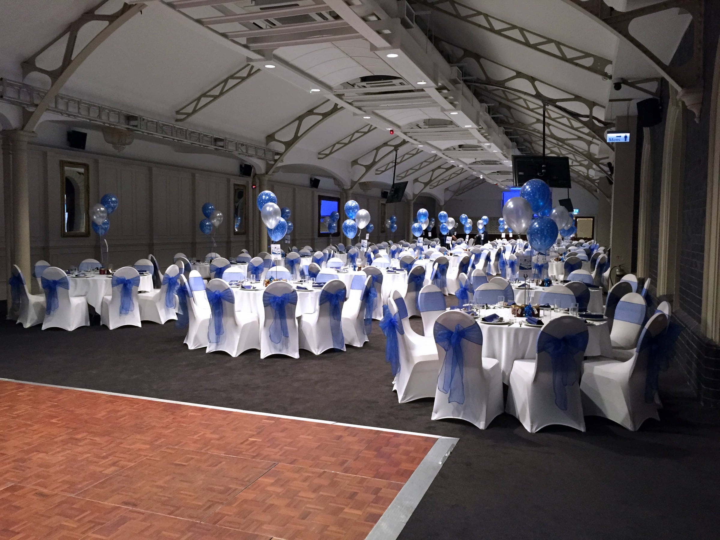 Professional Balloon Decorators Wolverhampton. Photo of venue decorated with balloon bouquets on tables. 